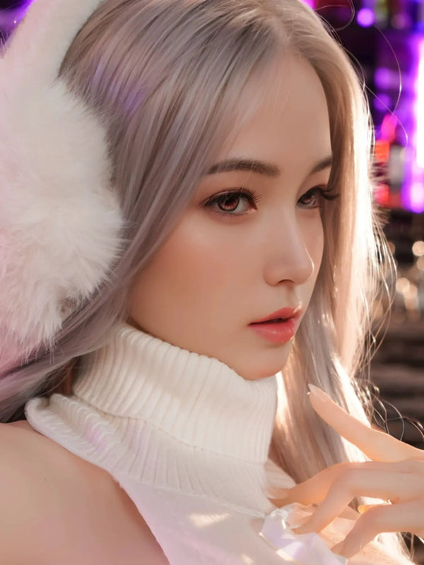 Close-up of a woman with long silver hair, wearing a white turtleneck and fluffy ear muffs, showcasing a soft, elegant appearance.